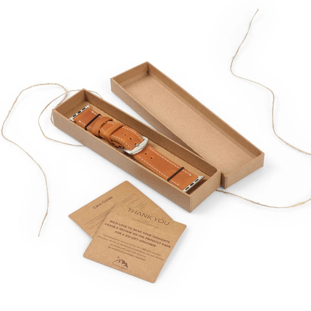 Full-grain leather Apple Watch strap by Yukon Bags in a gift box with care guide cards.